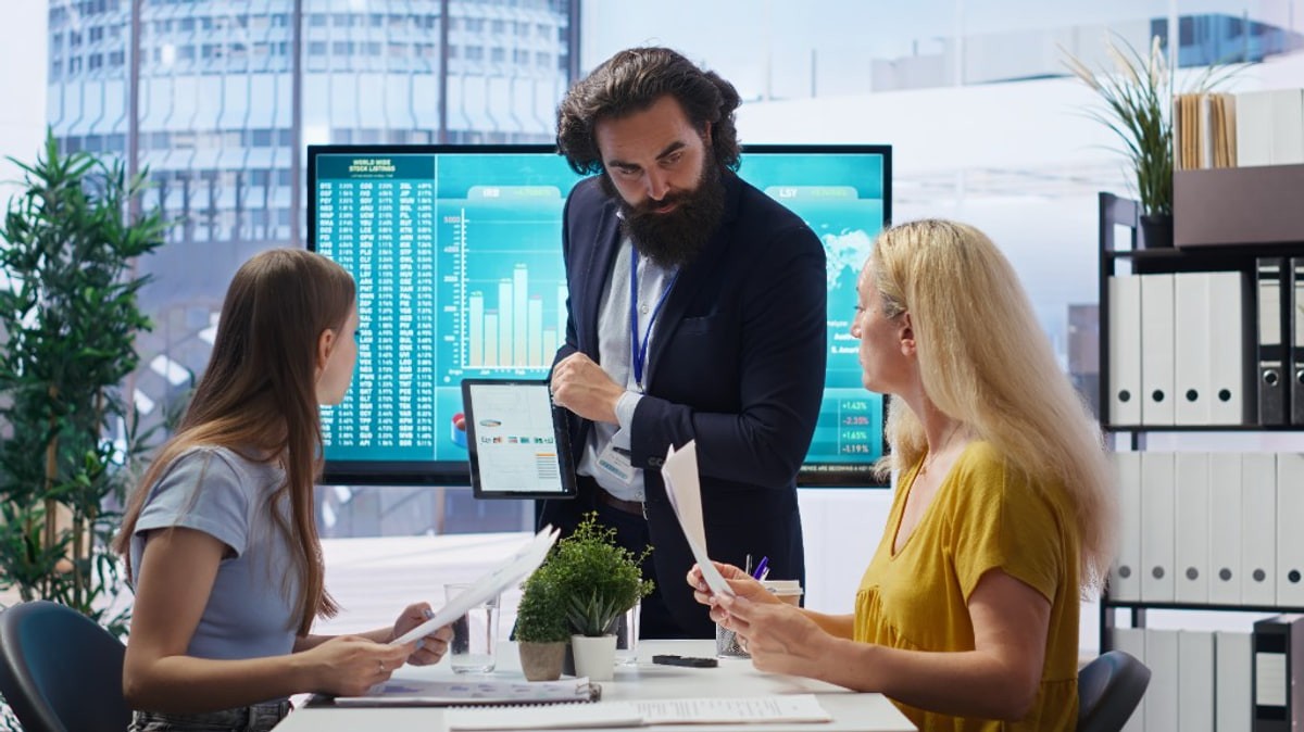 Small business owners reviewing documents with an adviser